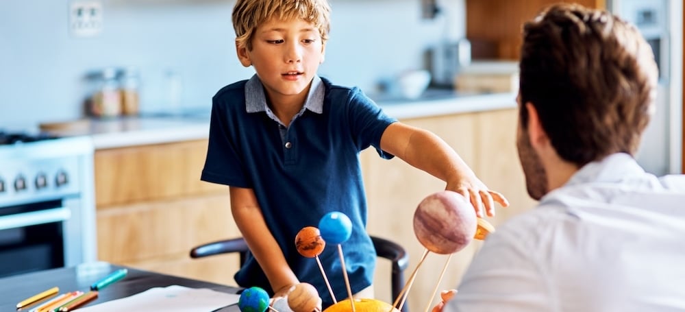 Father helping son with school project