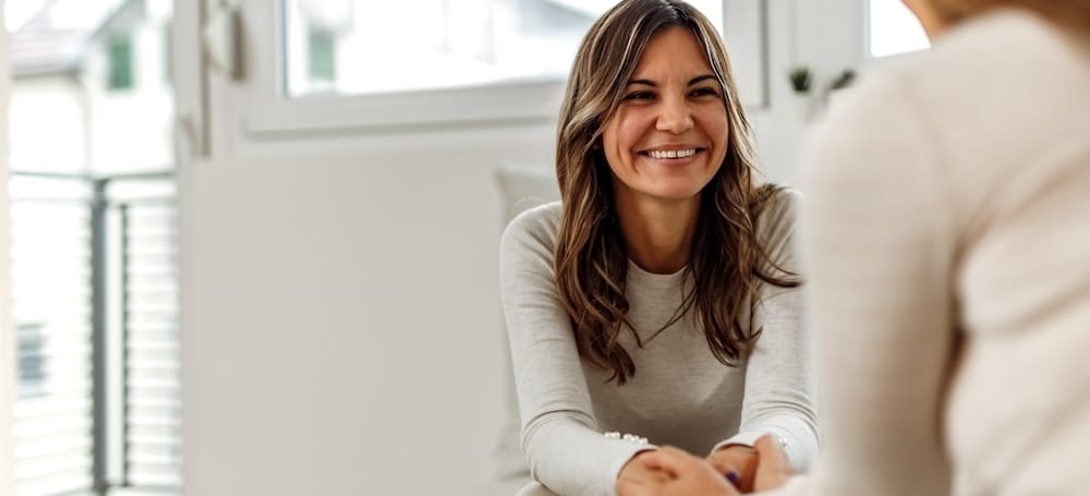 Smiling woman talking to psychologist